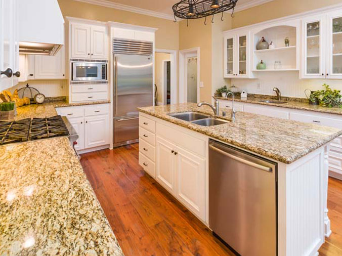 kitechn with stone countertops and stainless steel appliances